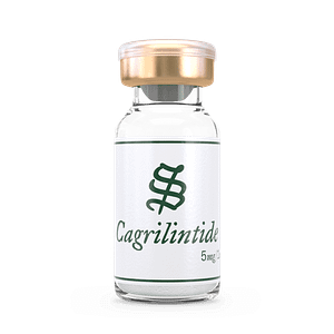 A clear glass vial labeled Cagrilintide in green text, capped in gold and white, holds a white powder. The vial is set against a black background.