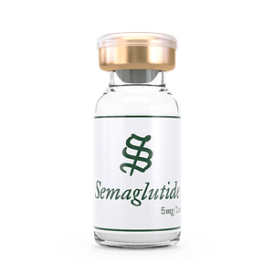 A clear glass vial with a gold cap labeled “Semaglutide 5mg/1mL” in green text, containing colorless liquid, sits on a white background.